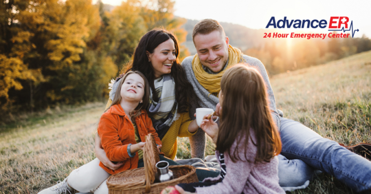 family laughing outside fall
